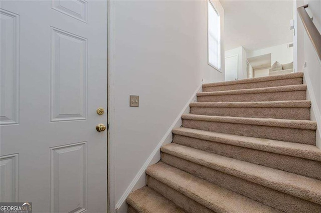 stairway featuring baseboards