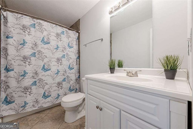 full bath with a textured ceiling, curtained shower, tile patterned flooring, toilet, and vanity