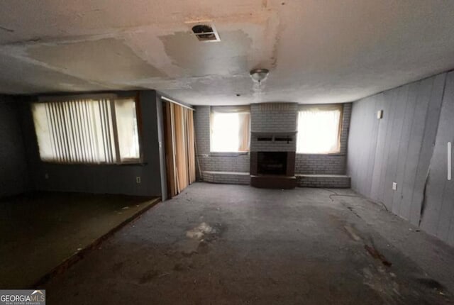 1188 Sunnydale Dr, Macon, GA 31217 - unfurnished living room with a brick fireplace and visible vents