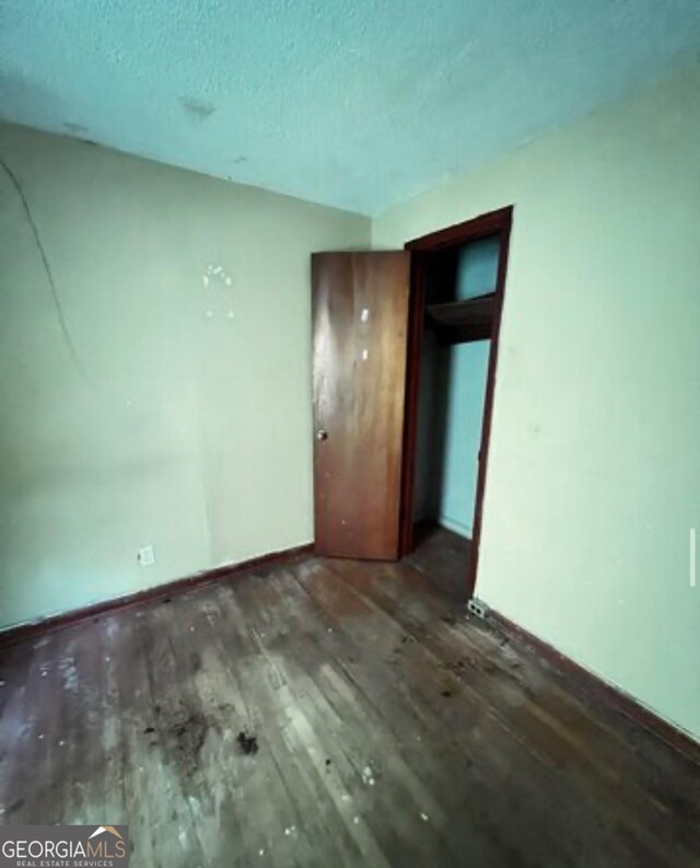 1188 Sunnydale Dr, Macon, GA 31217 - unfurnished room featuring a textured ceiling, baseboards, and wood finished floors