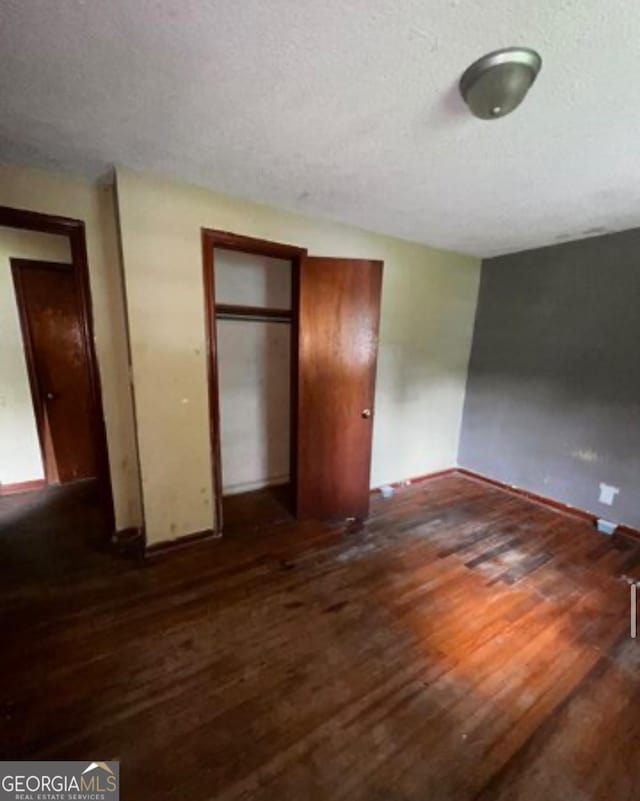 1188 Sunnydale Dr, Macon, GA 31217 - unfurnished bedroom featuring hardwood / wood-style flooring, a textured ceiling, and a closet
