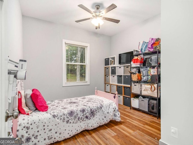 bedroom with a ceiling fan and wood finished floors