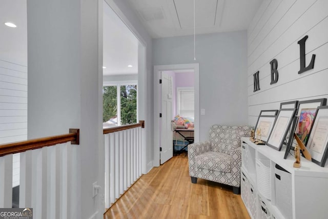 living area with attic access, light wood-type flooring, and recessed lighting