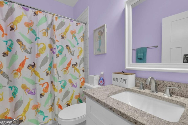 bathroom featuring toilet, a shower with curtain, and vanity