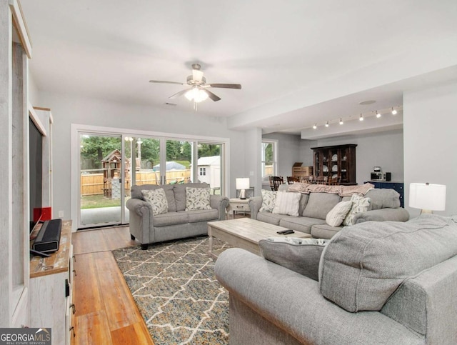 living room featuring wood finished floors and a ceiling fan