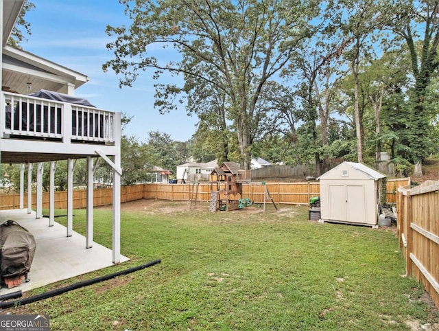 view of yard featuring an outbuilding, a patio area, a fenced backyard, and a storage unit