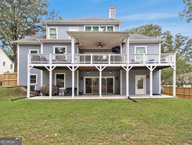 back of property with a yard, a patio, and fence