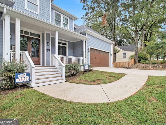 view of front of house with covered porch, concrete driveway, a shingled roof, and a garage