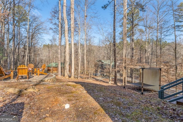 view of yard with a view of trees