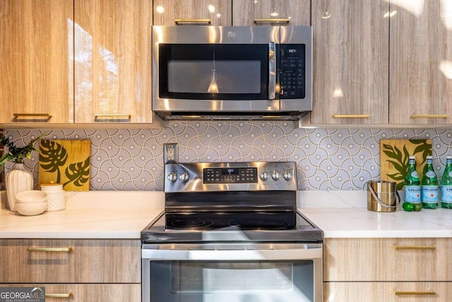 kitchen featuring appliances with stainless steel finishes, backsplash, and light brown cabinets