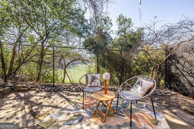 view of patio / terrace featuring fence