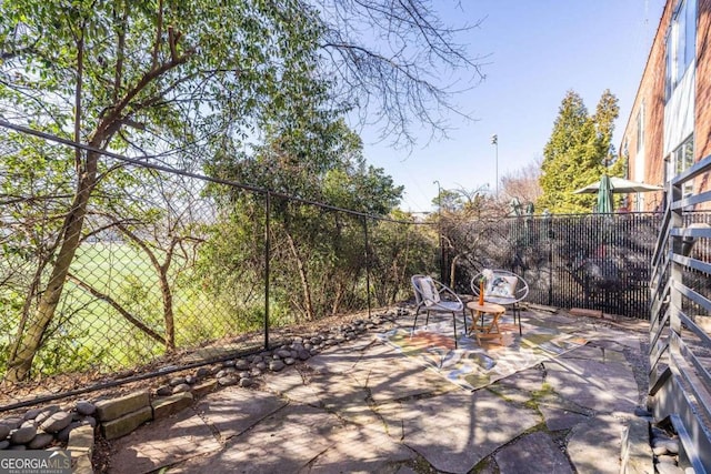 view of patio featuring fence