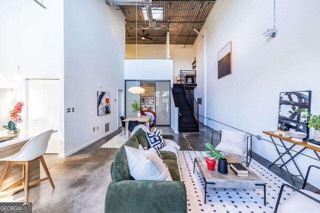 bedroom with a towering ceiling, a skylight, visible vents, and wood finished floors