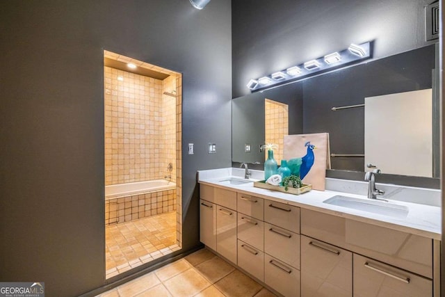 full bath with double vanity, a sink, and tile patterned floors