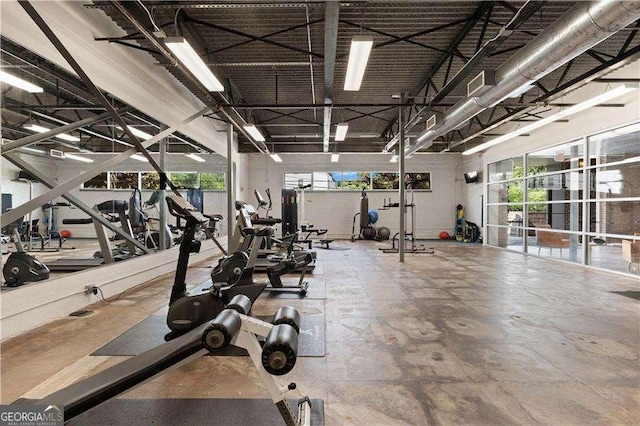 gym with a towering ceiling