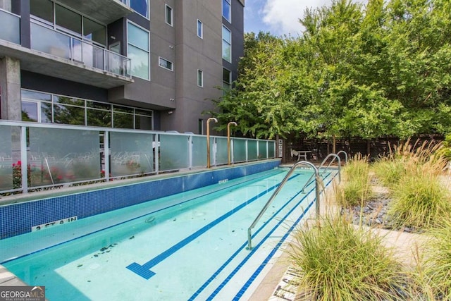 view of pool featuring fence