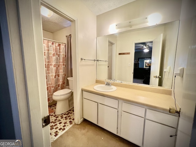 full bath with a textured ceiling, toilet, and vanity