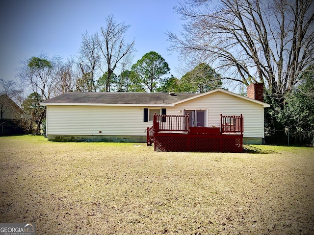 view of front facade with a chimney, a deck, and a front yard