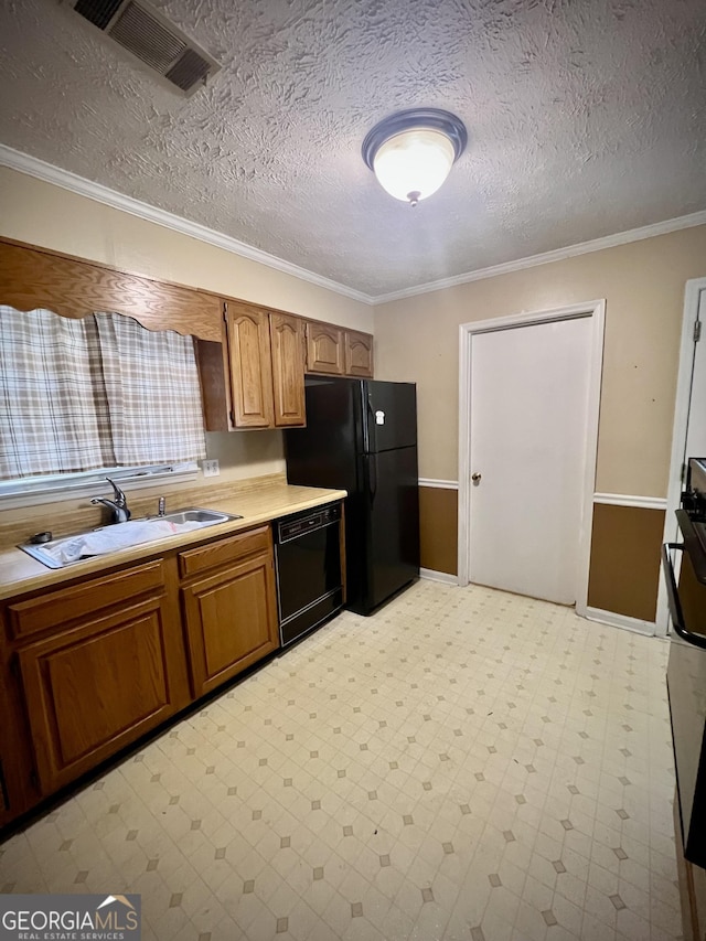 kitchen featuring visible vents, light floors, light countertops, black appliances, and a sink