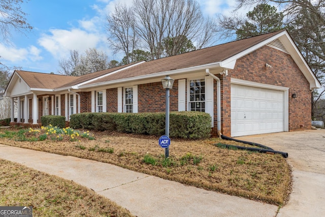 view of front facade with a garage, concrete driveway, and brick siding