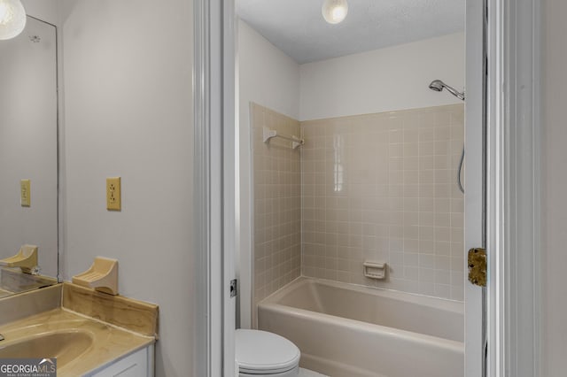 full bath featuring a textured ceiling, bathing tub / shower combination, vanity, and toilet