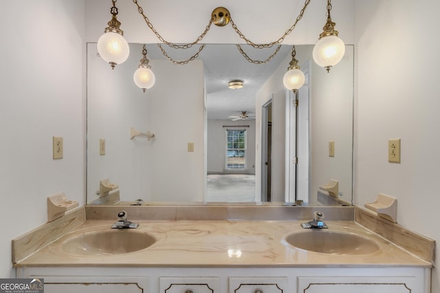 bathroom featuring a sink and double vanity