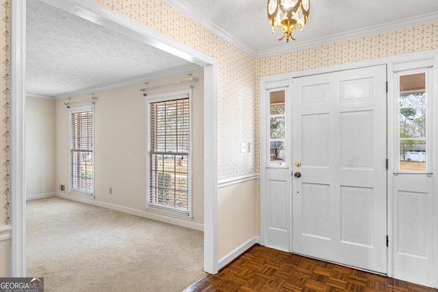 foyer featuring crown molding, a textured ceiling, and wallpapered walls