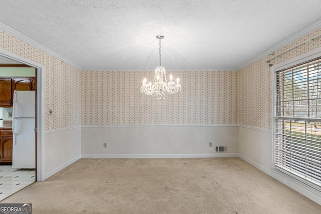 unfurnished dining area featuring a textured ceiling, visible vents, and wallpapered walls