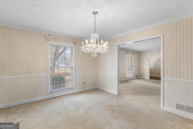 unfurnished dining area featuring wallpapered walls, a textured ceiling, ornamental molding, and a wainscoted wall