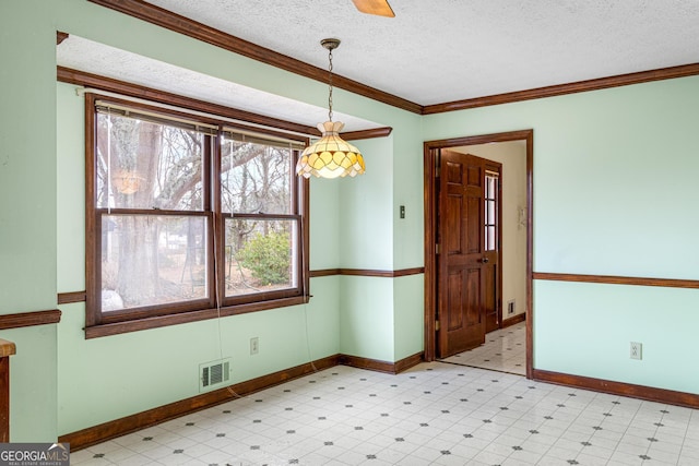 unfurnished dining area with light floors, visible vents, a textured ceiling, and ornamental molding