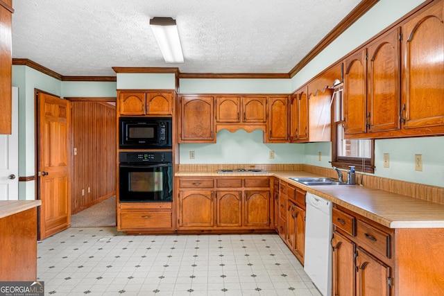 kitchen with black appliances, light floors, a sink, and brown cabinets