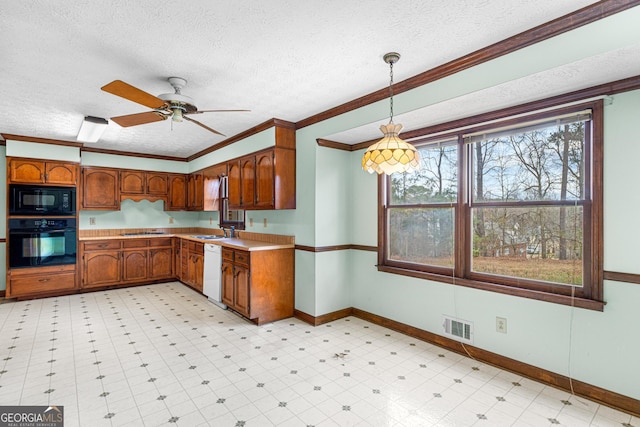 kitchen featuring light floors, light countertops, visible vents, a sink, and black appliances