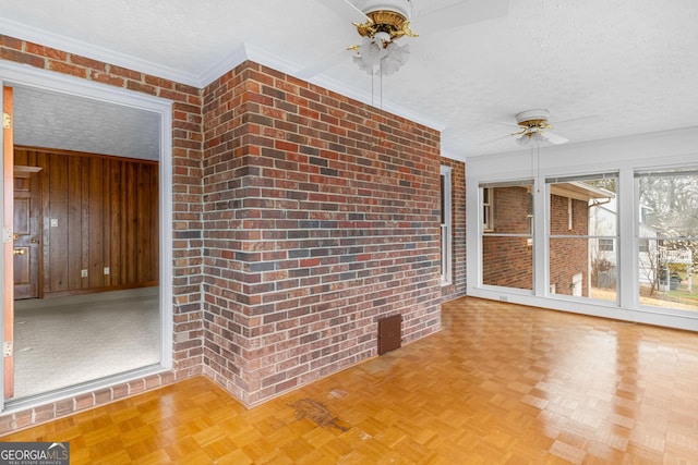 unfurnished sunroom with ceiling fan