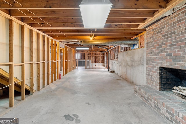 unfinished below grade area featuring a fireplace