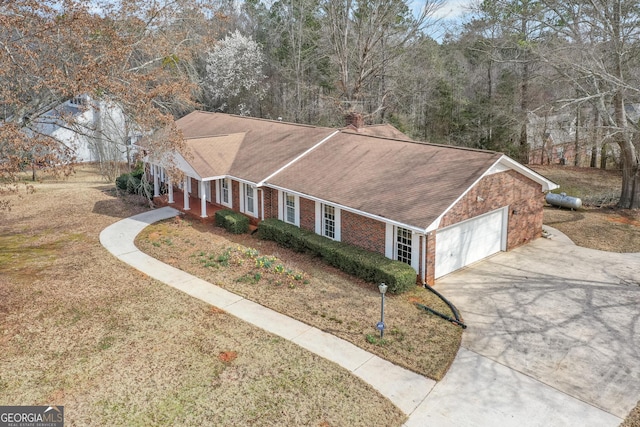 exterior space with a garage, driveway, brick siding, and a shingled roof