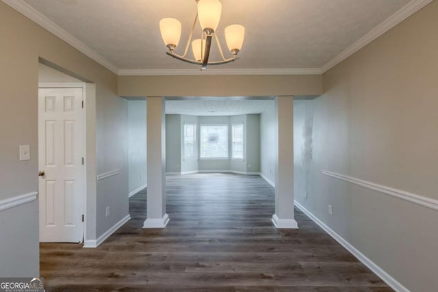 unfurnished dining area with baseboards, ornamental molding, and dark wood-style flooring