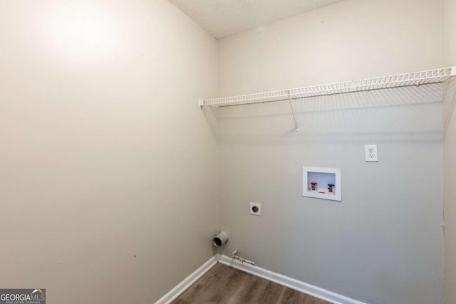 washroom with washer hookup, dark wood finished floors, hookup for an electric dryer, laundry area, and baseboards