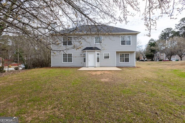 back of house with a patio and a lawn