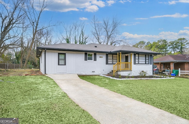 ranch-style house featuring a shingled roof, crawl space, a front yard, and fence