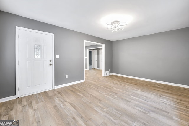 entrance foyer with baseboards and wood finished floors