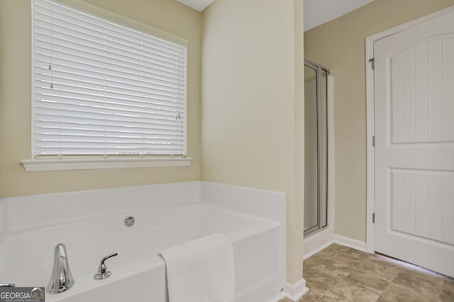 full bath featuring a garden tub and a shower stall