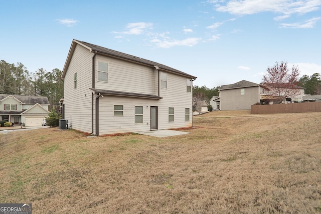 rear view of property featuring cooling unit, a patio area, and a lawn