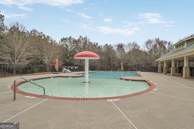 community pool featuring a patio and fence