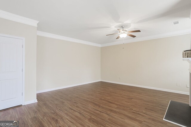 spare room with ceiling fan, crown molding, baseboards, and wood finished floors