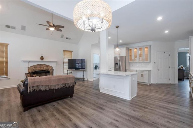 interior space featuring dark wood-style floors, open floor plan, white cabinetry, and stainless steel fridge with ice dispenser