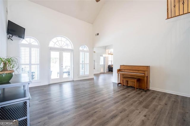 living room with high vaulted ceiling, french doors, visible vents, and wood finished floors