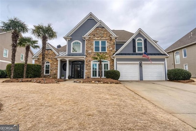 view of front of property featuring a standing seam roof, metal roof, and concrete driveway