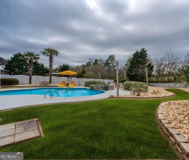 view of pool with a lawn, fence, and a fenced in pool