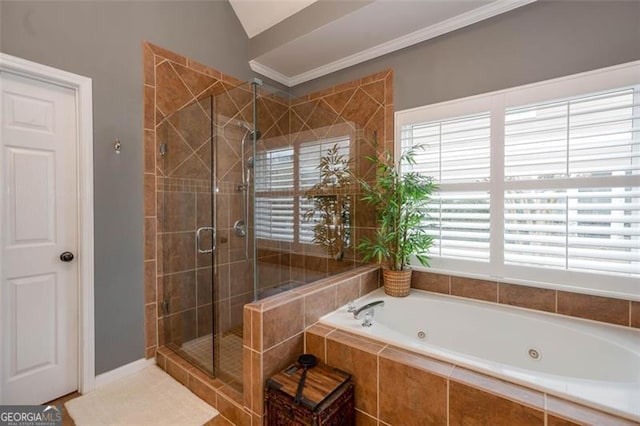 bathroom featuring a stall shower, a tub with jets, and ornamental molding