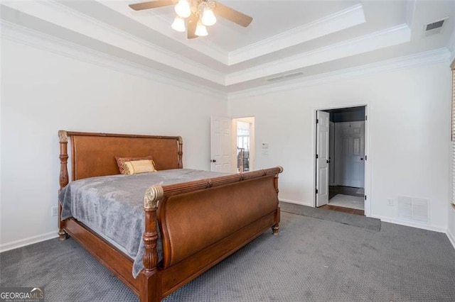 bedroom featuring a tray ceiling, carpet, and visible vents